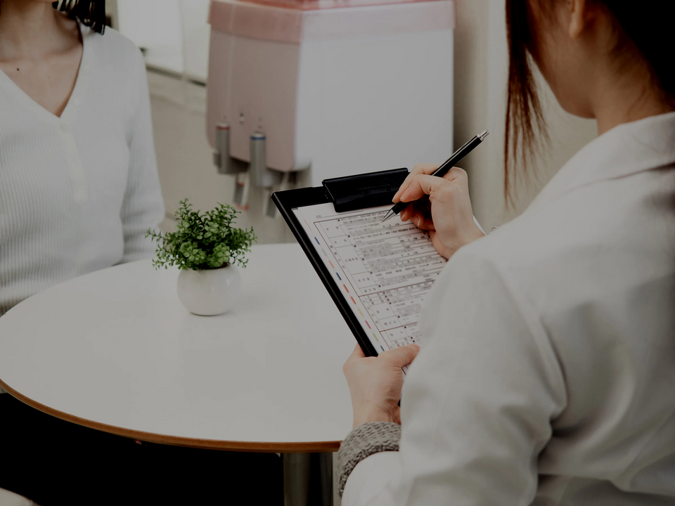 woman writing on a clipboard